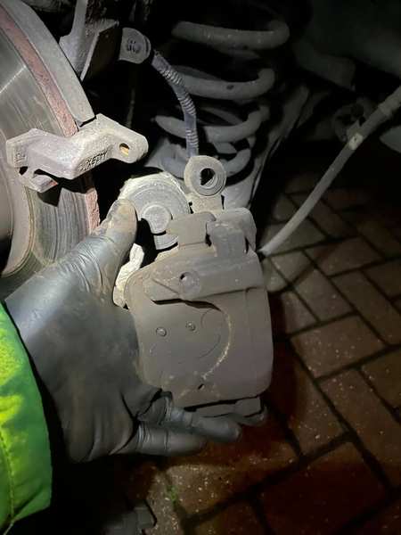 Rear caliper removed — brake service in progress